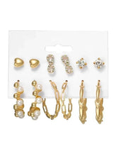 Gold-tone earrings set on card: pearl drops, hoops, and crystal stud accents
