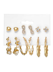 Gold earring set for women featuring heart studs, pearl hoops, and sparkling designs for versatile styling.
