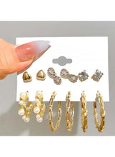 Gold-tone earrings set on card: pearl drop hoops, textured hoops, and crystal studs