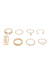 Gold-tone ring set of eight with assorted bands and small clear stones