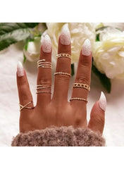Gold fashion ring set for women displayed on manicured hand with stylish nail design