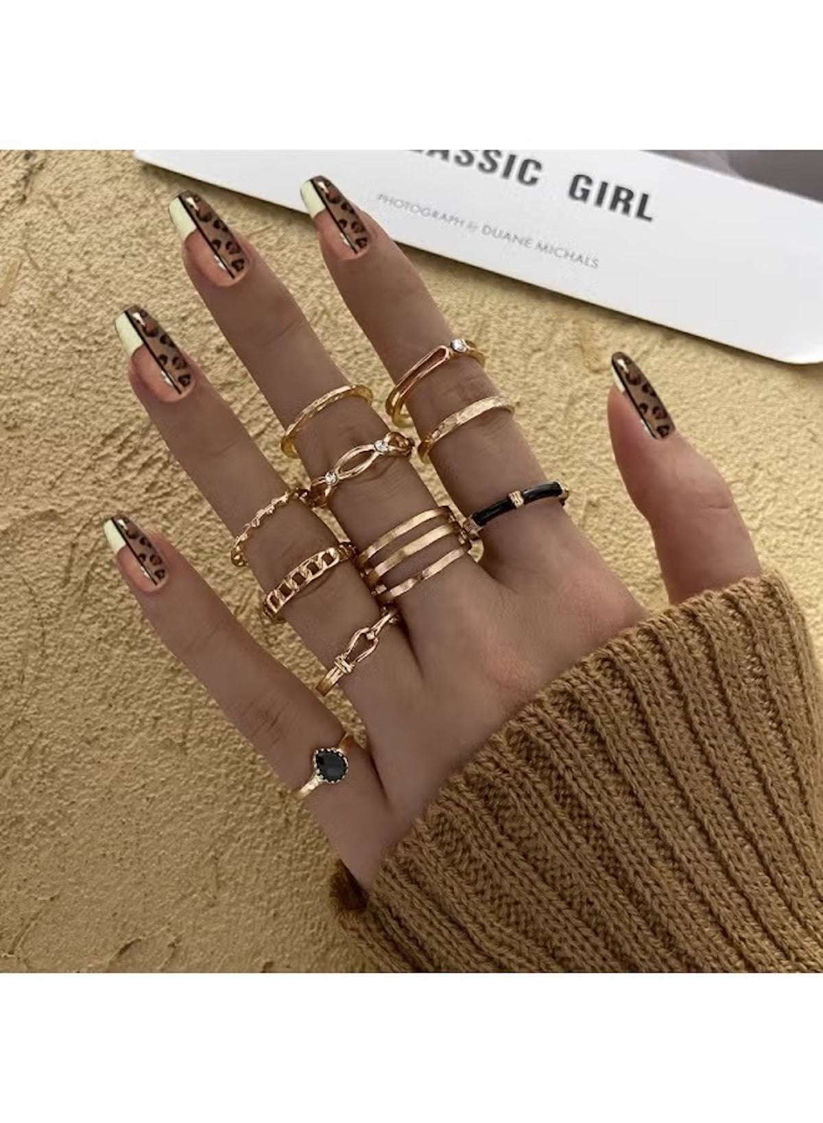 Stylish gold fashion ring set for women displayed on a hand with elegant nail art