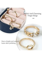 Gold-tone finger ring set worn on hand, featuring small clear stones