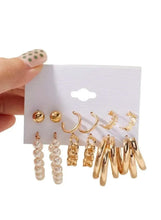 Gold hoop and pearl earring set with multiple studs and dangling hoops on card