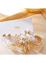 Mixed gold hoop and pearl earrings set with large spiral hoops and pearl clusters