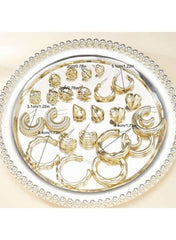 Gold hoop and stud earring set for women on a decorative tray showcasing various styles and sizes