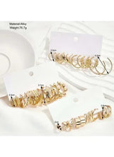 Gold-tone hoop earrings set with assorted hoops on two hanging cards