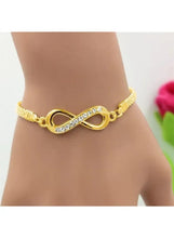 Gold infinity link mesh bracelet with blue crystal stones, adjustable fit on wrist