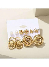 Gold-tone earring set with pearl studs, floral charms, and layered knot hoop studs