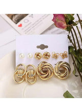 Gold-tone earring set with pearl studs, floral charms, and double knot hoop studs