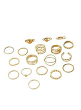 Gold tone knuckle ring set with mixed bands and rings, laid out flat