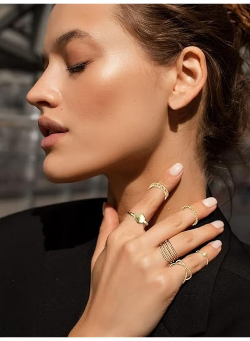 Fashionable gold knuckle rings set for women worn on fingers with elegant hand pose