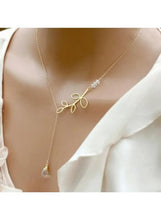 Gold chain necklace with leaf-bow pendant and teardrop pearl drop
