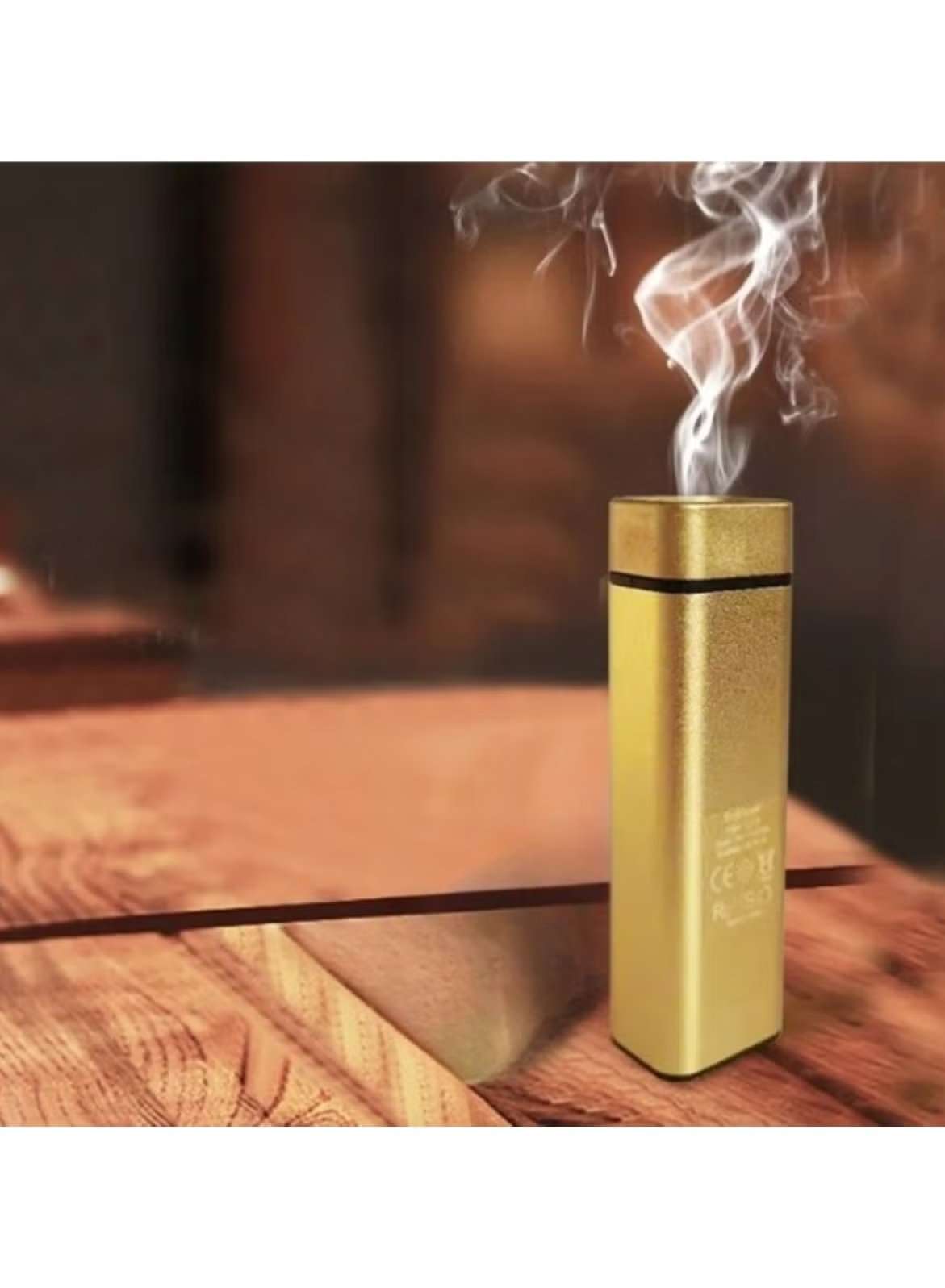 Huitich gold mini electric aroma burner releasing fragrant smoke on wooden surface