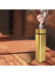 Huitich gold mini electric aroma burner releasing fragrant smoke on wooden surface