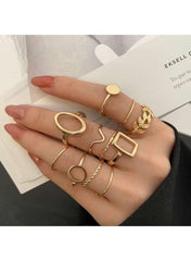 Gold minimalist ring set for women featuring various designs on multiple fingers
