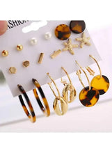 Earring set with pearl-like studs, gold bar pieces, star earrings, and tortoise-look hoops