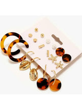Mixed earring set with tortoise-look hoops, gold star charms, and amber round stud drops