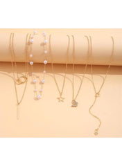 Gold necklace set for women featuring layered designs with pearls and charms
