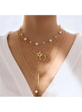 Gold tone layered necklaces with pearl beads, heart pendant and small star charm