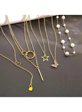Gold tone necklace set with long chains, star pendant and white pearl bead drops