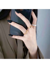 Elegant gold plated pearl ring set worn on fingers with long black nails, highlighting stylish design