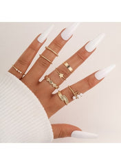 Stylish gold plated women’s ring set featuring various designs on elegantly manicured fingers