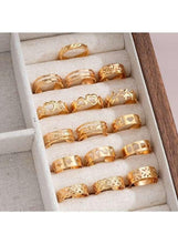 Gold tone ring set in fabric organizer, assorted textured and patterned bands