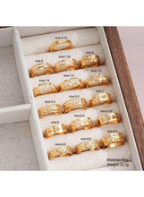 Gold tone ring set in a fabric display box, multiple assorted bands