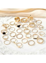 Gold-tone ring set flat lay, assorted rings with textured and crystal designs
