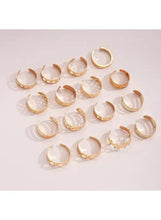 Gold tone ring set with hoop-style bands and pearl-like accents