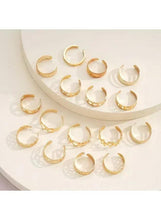 Gold tone ring set with textured bands and small sparkle details