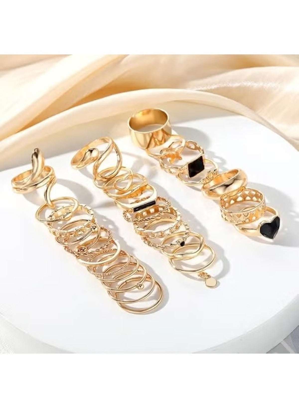 Elegant gold ring set for women featuring multiple stylish designs and black accent stones