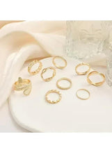 Gold ring set with snake and chain motifs: nine stacked bands