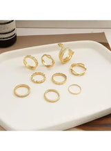 Gold snake & chain ring set with nine rings, including textured and linked styles