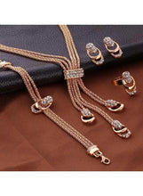Gold-tone crystal tassel necklace with oval charms and matching hoop earrings