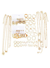 Gold-tone multi-piece jewelry set with layered necklaces, rings, and dangling earrings