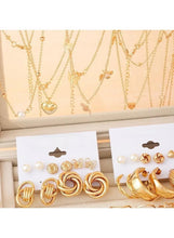 Gold-tone earring and ring set on display cards in a jewelry box tray