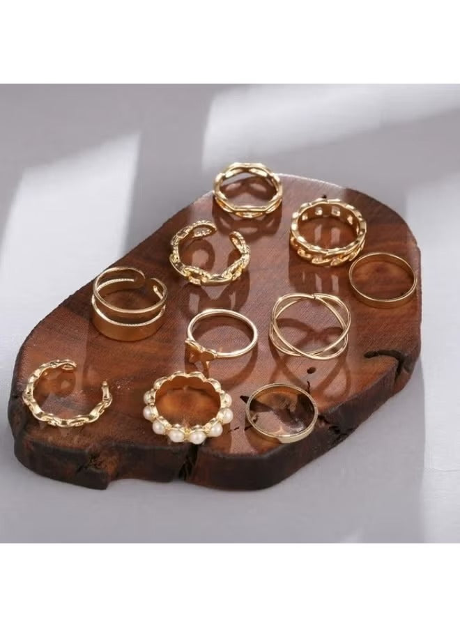 Gold tone ring set for women displayed on a wooden platter featuring various textured designs