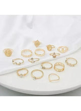 Gold-tone ring set scattered on a white plate, mixed vintage styles