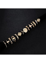 Gold-tone ring set with stackable bands and engraved face motifs