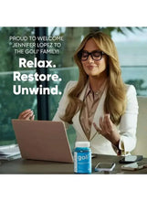 Blue ashwagandha gummies bottle on desk with woman holding it, white cap