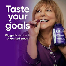 Woman holding a purple gummy next to Goli Dreamy Sleep supplement bottle