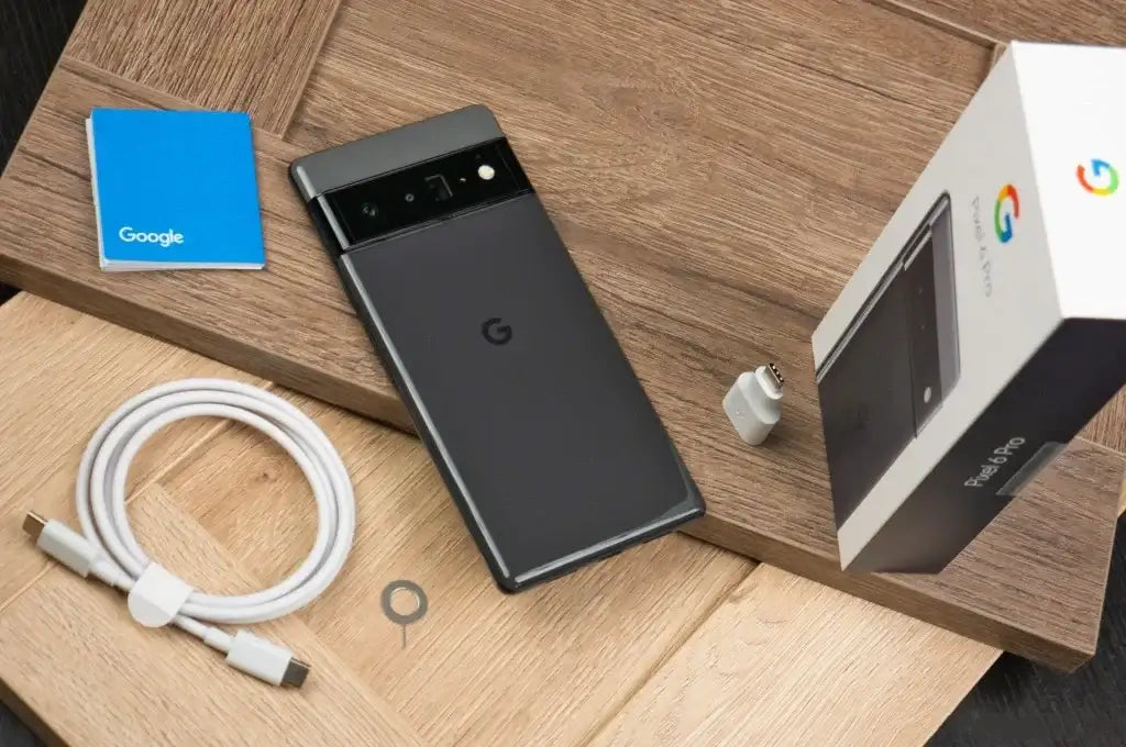 Google Pixel 6 Pro 5G unlocked smartphone back in black with box, USB C cable, charger, SIM tool on wood