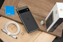 Google Pixel 6 Pro 5G unlocked smartphone back in black with box, USB C cable, charger, SIM tool on wood