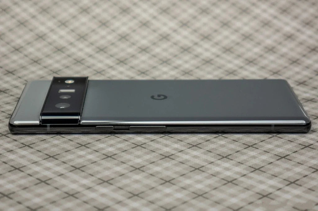 Google Pixel 6 Pro 5G unlocked gray phone lying on fabric surface showing rear camera bar and power buttons