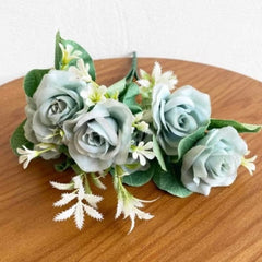 Huitich green artificial rose bouquet with soft green roses and white accent flowers on wooden surface