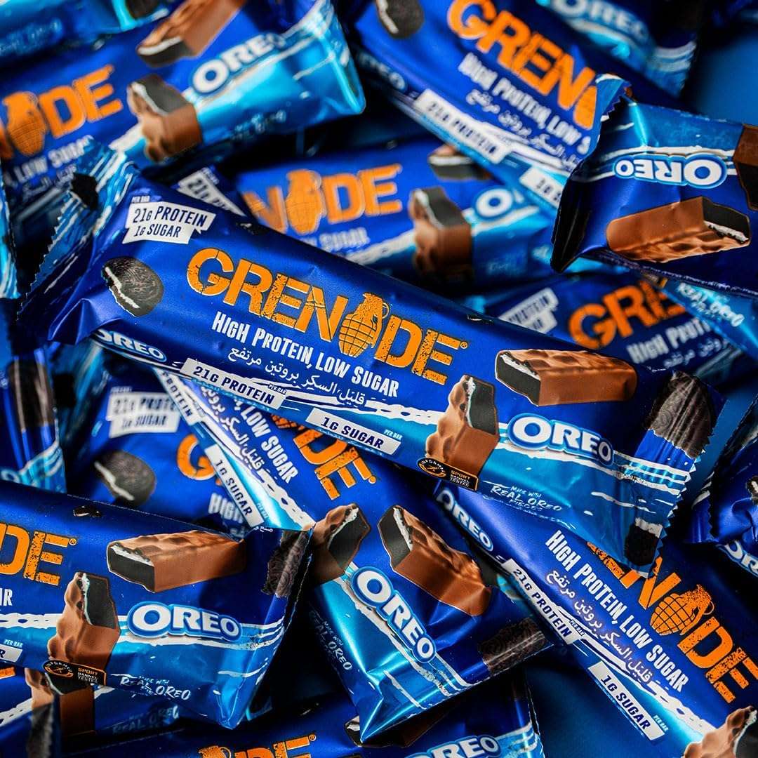 Grenade Oreo protein bars blue wrappers scattered showing high protein low sugar label and chocolate coating