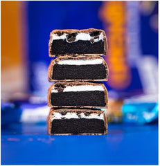 Stacked cross section of Grenade Oreo protein bars showing chocolate coating dark cookie layers and cream filling