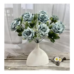 Huitich grey artificial flower arrangement in white vase on wooden table with sheer curtain background